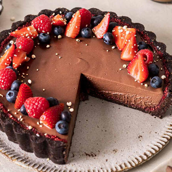 Chocolate Mousse Torte: A silky, decadent dessert made with a chocolate crust and topped with three types of berries. Whipped cream available on request.