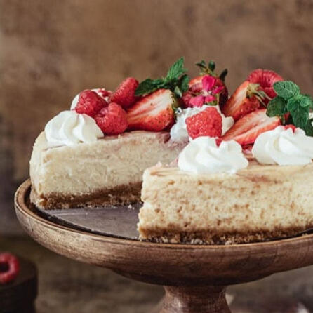 Cheesecake: A deliciously light and fluffy cheesecake down with a graham cracker crust and topped with fresh rolanberries and whipped cream.