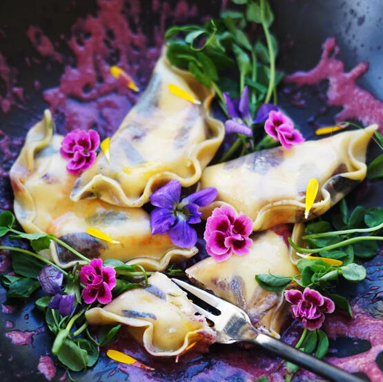 Floral & Cheese Pierogi: Served in a set of three this sour cream dough is filled with Garlean Cheese, popoto, and rosehip before boiled and sauteed with smooth butter. Served with a beetroot sauce.